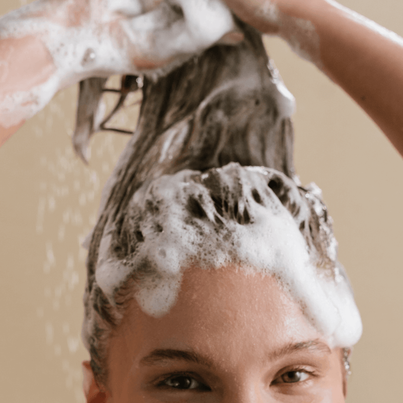 A woman shampooing her hair