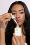 girl holding scalp serum dropper